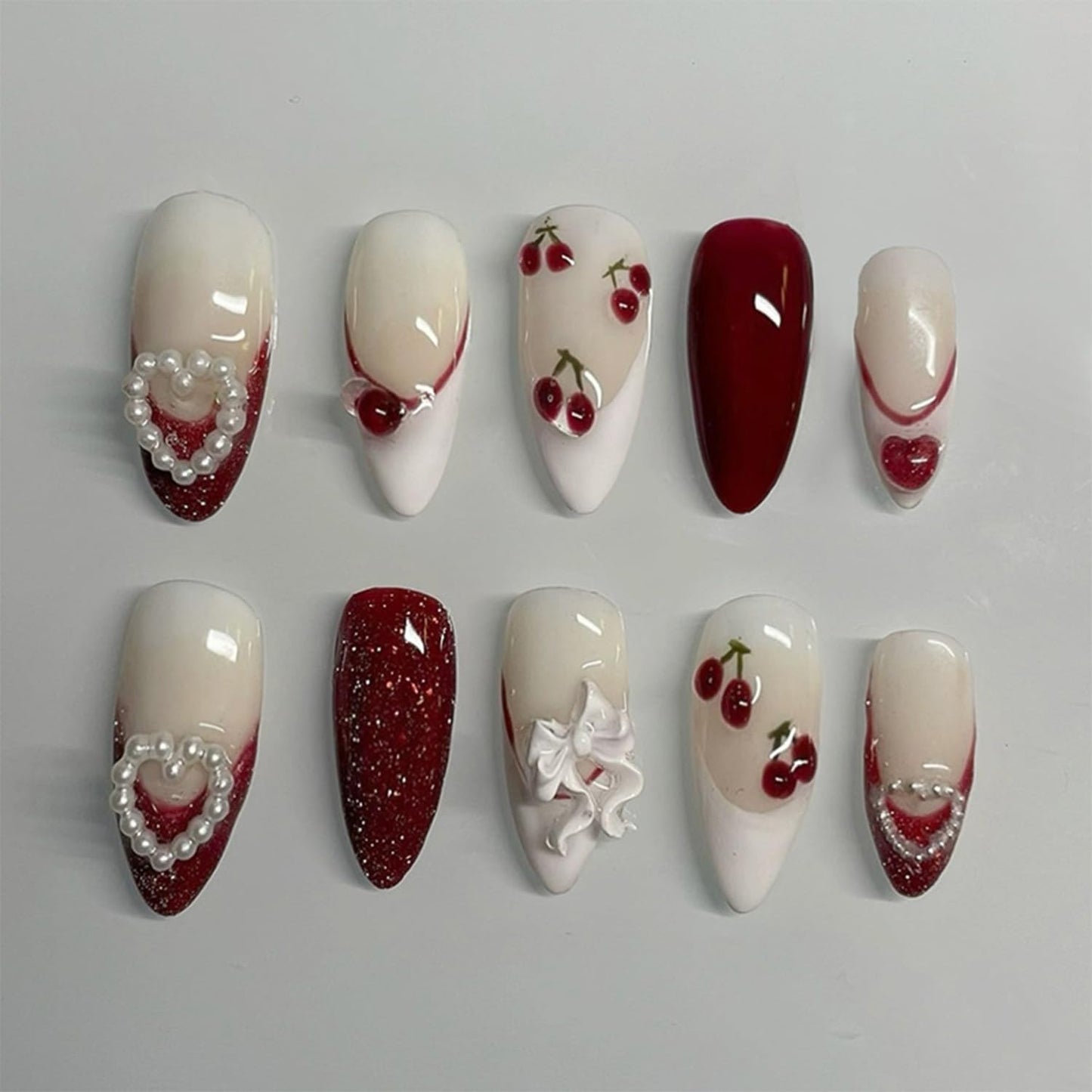 24Pcs Valentines Press on Nails Medium Almond Fake Nails with White Bow Cherry Heart Designs Artificial Acrylic Glue on Nails Red French Tip False Nails 3D Pearl Full Cover Stick on Nail for Women