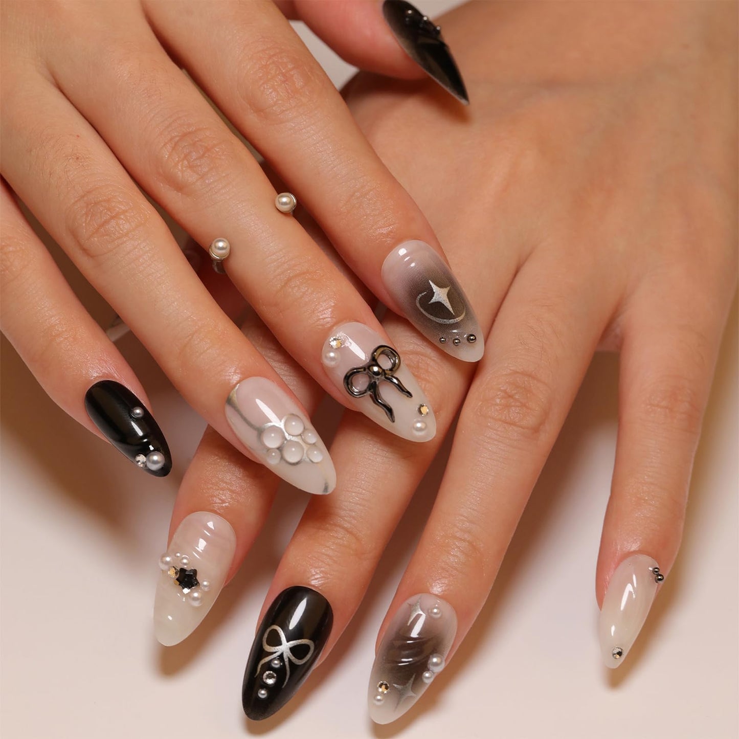 LBPEPAMZ Black Press on Nails Medium Almond Fake Nails with 3D Alloy Bow Pearl Designs Black Gradient Full Cover False Nail Water Drops Silver Star Glossy Acrylic Nails Stick on Nail for Women 24Pcs