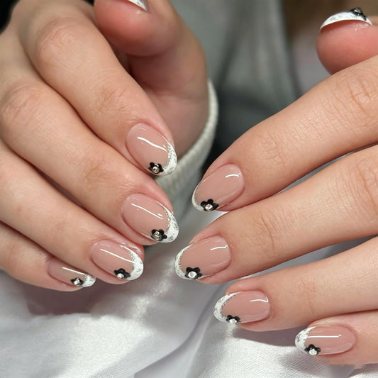 24Pcs French Tip Press On Nails Short Almond Fake Nails Nude Pink with Black Flowers & Silver Rhinestones Glossy Acrylic False Nails with Glitter Edge,Full Cover Stick On Nails for Women DIY Manicure