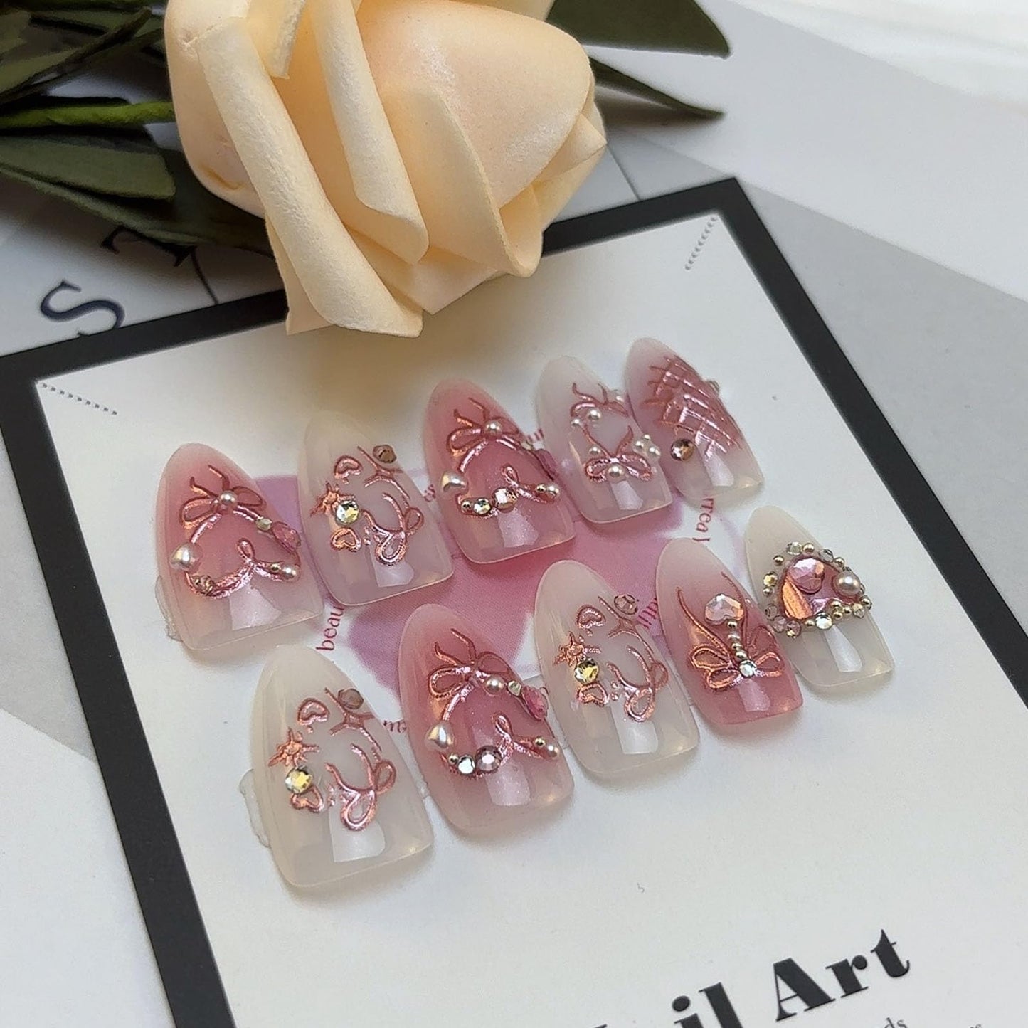 LBPEPAMZ Pink Press on Nails Medium Almond Fake Nails with 3D Heart Pearl Rhinestones Designs White Gradient Bow Silver Star Stick on Nails Flower Charms Full Cover Glue on Nails for Women Girls 24Pcs